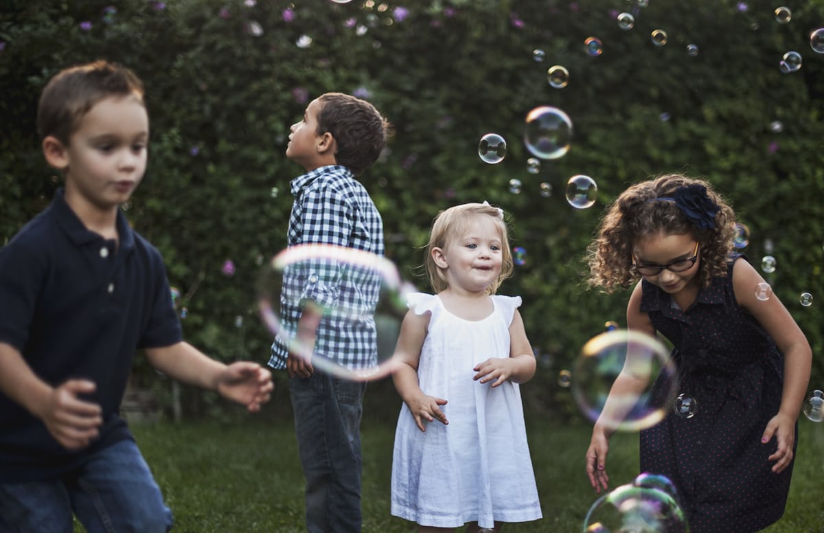 children outside with bubbles